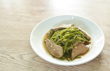 stir fried garlic chives with pork liver in soy sauce on plate
