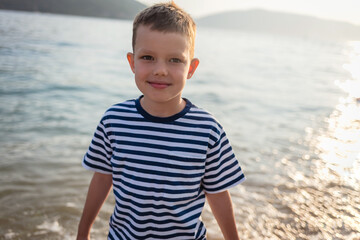 Beach, relax and travel child portrait with smile on sand for peaceful summer break. Young and happy boy on the beach, enjoying freedom and leisure with seaside walk.