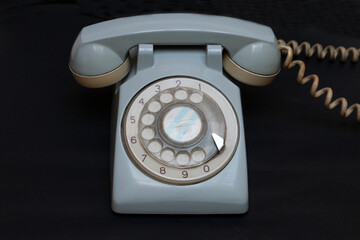 old telephone on black background