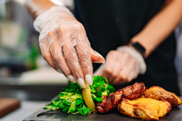 woman chef hand cooking grilled meat with baked potatoes and salad