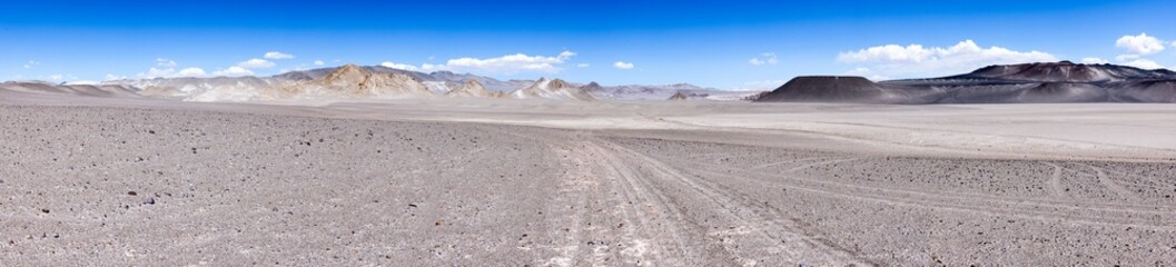 Fototapeta na wymiar Campo de Piedra Pomez - a bizarre but beautiful landscape in the Argentinian highlands with a huge field of pumice, volcanic rocks and dunes of sand in the Puna - Traveling and exploring South America