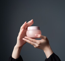 Close up woman hands holding bottle of pink face cream, Skin care, moisturizing and nourishing or sunscreen, Generative AI Illustration