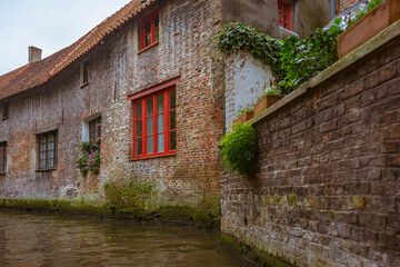Bruges, Belgium. Historic center of the city. Windows with brick wall of medieval houses on Rozenhoedkaai canal. West Flanders Province, Belgium. Cityscape of Bruges (Brugge).