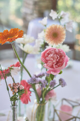 Floristics. Floral decoration of the wedding in pastel colors. Many flowers in different vases and vessels