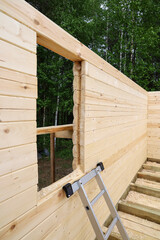 Construction of wooden village house of profiled beam