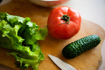 salad, cucumber, posymore and greens on a wooden board. fresh farm products for a healthy lifestyle and diet