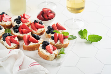 American flag sandwich with strawberries, blueberries, whipped sweet cream, soft cheese on toast bread. 4th of July American Independence Day food. Independence or Patriotic Day breakfast idea Mock up