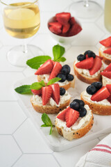 American flag sandwich with strawberries, blueberries, whipped sweet cream, soft cheese on toast bread. 4th of July American Independence Day food. Independence or Patriotic Day breakfast idea Mock up