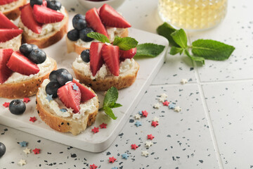 American flag sandwich with strawberries, blueberries, whipped sweet cream, soft cheese on toast bread. 4th of July American Independence Day food. Independence or Patriotic Day breakfast idea Mock up