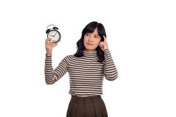 Fototapeta premium Portrait of thinking young Asian woman with sweater shirt holding alarm clock isolated on white background