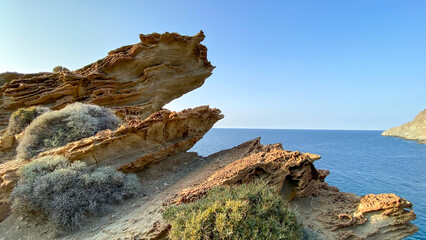 Calm Gokceada (Yildizkoy-Blue bay ) landscape with sea to the skyline, and a craggy outcrop of rocks to the left. Gokceada, Imbros island, Turkey