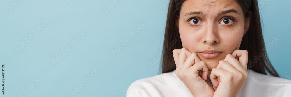 Wall mural young white brunette woman expressing surprise at camera