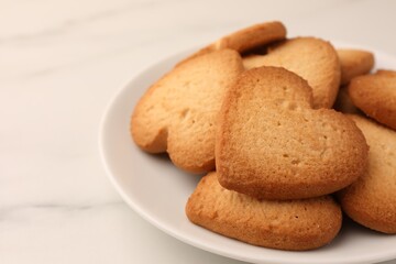 Heart shaped Danish butter cookies on white marble table, closeup