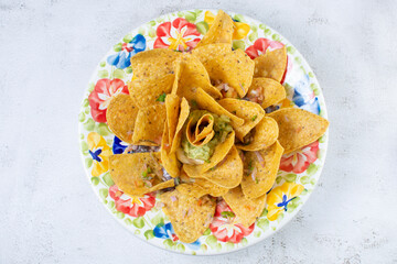 Mexican nachos with guacamole, pico de gallo, accompanied by hot sauce