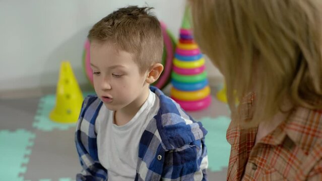 Unlocking Verbal Potential: A Touching Visual Story of a Child's Speech Development Progress through Interactive Language Exercises with a Speech Therapist. High quality 4k footage