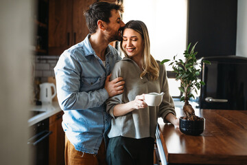Plant care. Nature protection concept. Smiling environmentally friendly couple with houseplants.