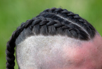 Hairstyle in the form of braids on the head of a man