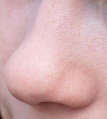 Fototapeta premium Close-up of a girl's nose. Macro
