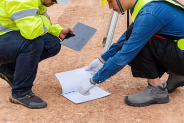 Foreman's hand pointing at road construction blueprint