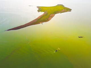 Aerial view of Ben Nom fishing village, a brilliant, fresh, green image of the green algae season...