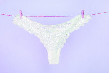 White sexy lace panties hanging on clothesline