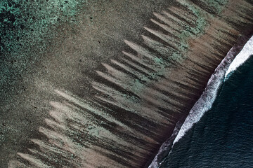 Fototapeta na wymiar Aerial view of the Ningaloo reef from the sky. Waves and stripes landscape with drone. Beautiful location, Exmouth, Western Australia.