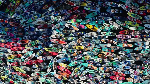 St. Petersburg, summer 2022:A lot of people on paddle boards on the water during festival fontanka SUP, top down aerial view. Crowd of people on SUP, looks like colorful mosaic