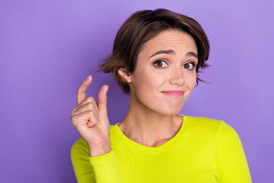 Photo of unsatisfied young person arm fingers demonstrate tiny small size gesture isolated on violet color background