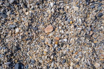 Crushed stone on the seashore. Selective focus on object. The stones were laid on the ground in the garden as a background. Background blur. Pebble stones background.
