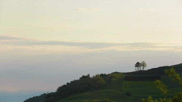Serene skies: Sunset clouds over verdant landscape