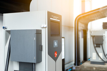 Close-Up electric car charging station. Plug for vehicle with electric engine. Charging point at car public parking lot. Future transport technology concept. EV charger. Clean energy for the world.