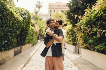 Happy gay couple hugging in the park. LGBT gay couple concept.