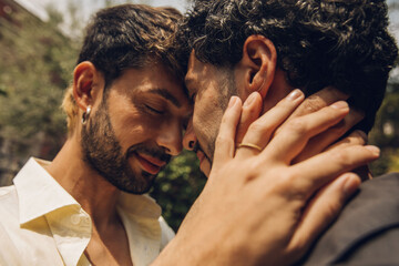 Gay couple in love embracing each other outdoors. Close-up portrait of a gay couple.