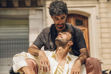 men couple sitting in the city