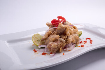 chicharon breaded fried fish and corn, aji with symbol dish of Peruvian cuisine. Peru.