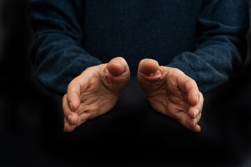 man hands in gesture of acceptance or protection 
