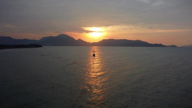 Cinematic aerial view of sunset waves off the coast of Aceh, Indonesia.