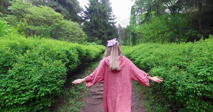 The girl is walking in forest