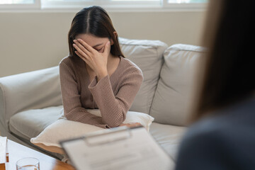 woman with mental health problems is consulting. psychiatrist is recording the patient's condition...