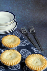 Mini meat pies, hot from the oven, with space for text.