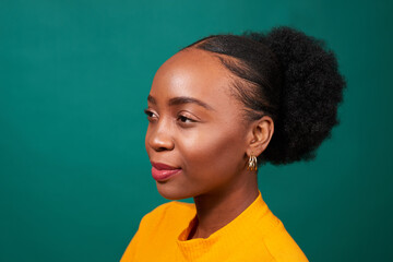 Beautiful Black woman, studio teal background, fashion lifestyle portrait