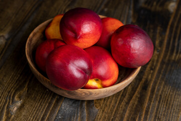 Nectarines folded in a wooden bowl