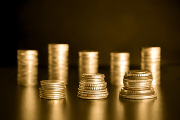 stack of golden money coin on black background. Business and financial concept. 
