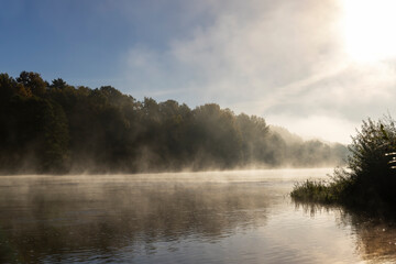 Fototapeta na wymiar Fog-covered river in the autumn season