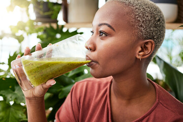 Black woman, diet and drinking natural smoothie for vitamins, fiber or health and wellness in...