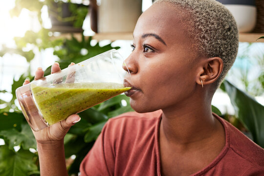 Black woman, diet and drinking natural smoothie for vitamins, fiber or health and wellness in store. Face of African female person with healthy beverage, drink or organic fruit juice to lose weight