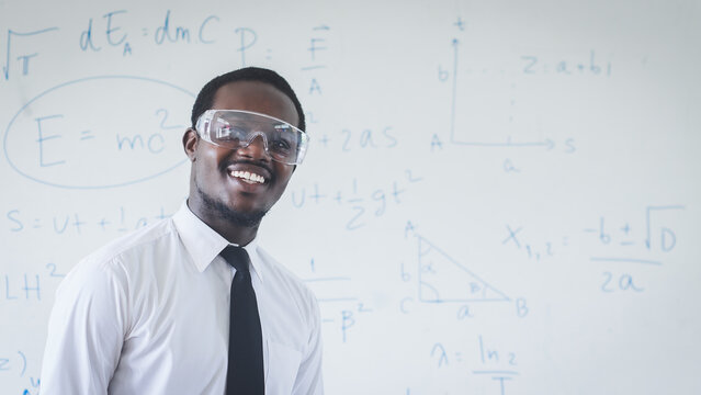 Smile african teacher in white shirt is experimenting and explaining a science lesson in the classroom.Concept of sciences education - Powered by Adobe