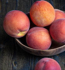 Ripe fresh peaches on a wooden table