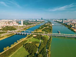 Fototapeten Aerial drone view of Danube river in Vienna Austria cityscape with danube island © MysteryShot