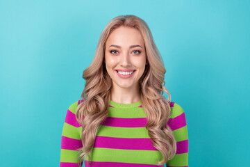Photo portrait of pretty young girl toothy smile look camera wear trendy striped outfit isolated on cyan color background
